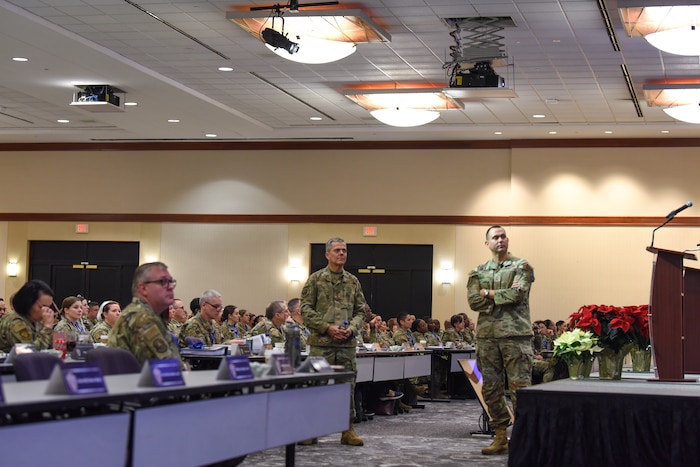 Image of Airmen talking to a group of people.