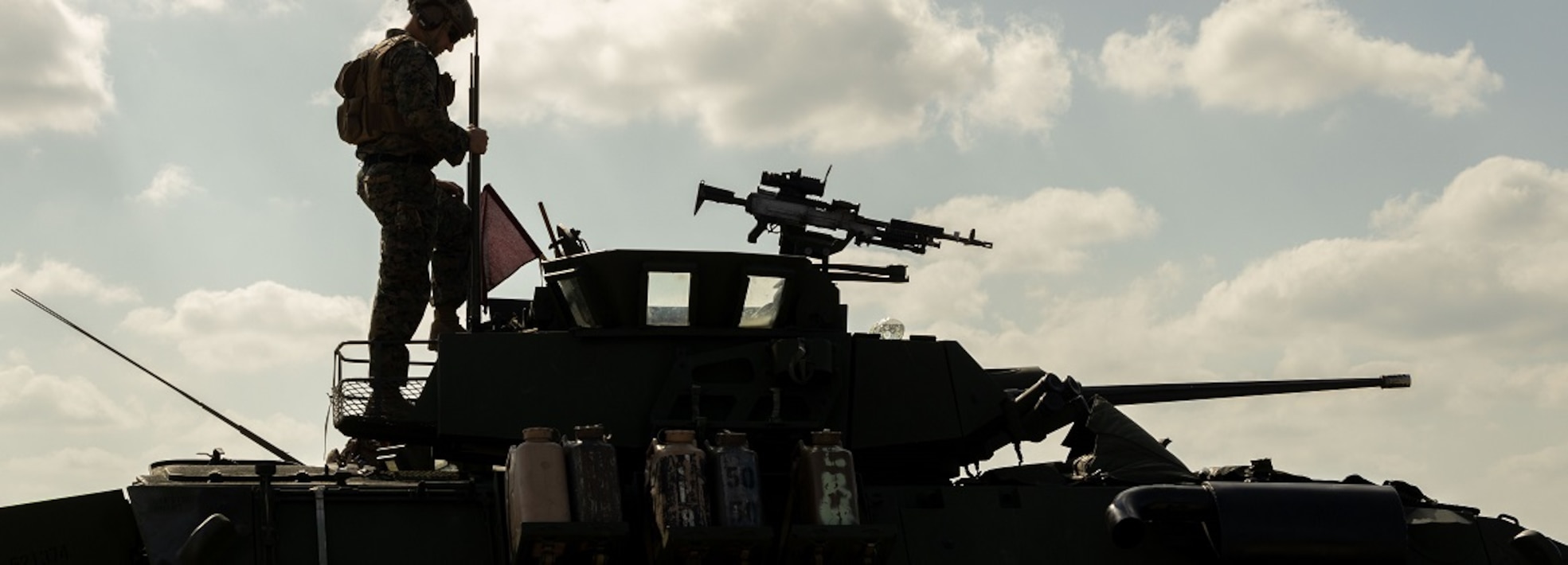U.S. Marine with the 3rd Light Armored Reconnaissance Battalion, 31st Marine Expeditionary Unit, observes the trajectory of the 25mm autocannon mounted on the light armored vehicle during weapons field training at Camp Schwab, Okinawa, Japan, Nov. 27, 2024.