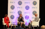 Three speakers sit on a panel at the FMS Symposium