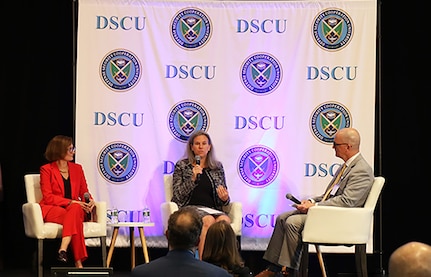 Three speakers sit on a panel at the FMS Symposium