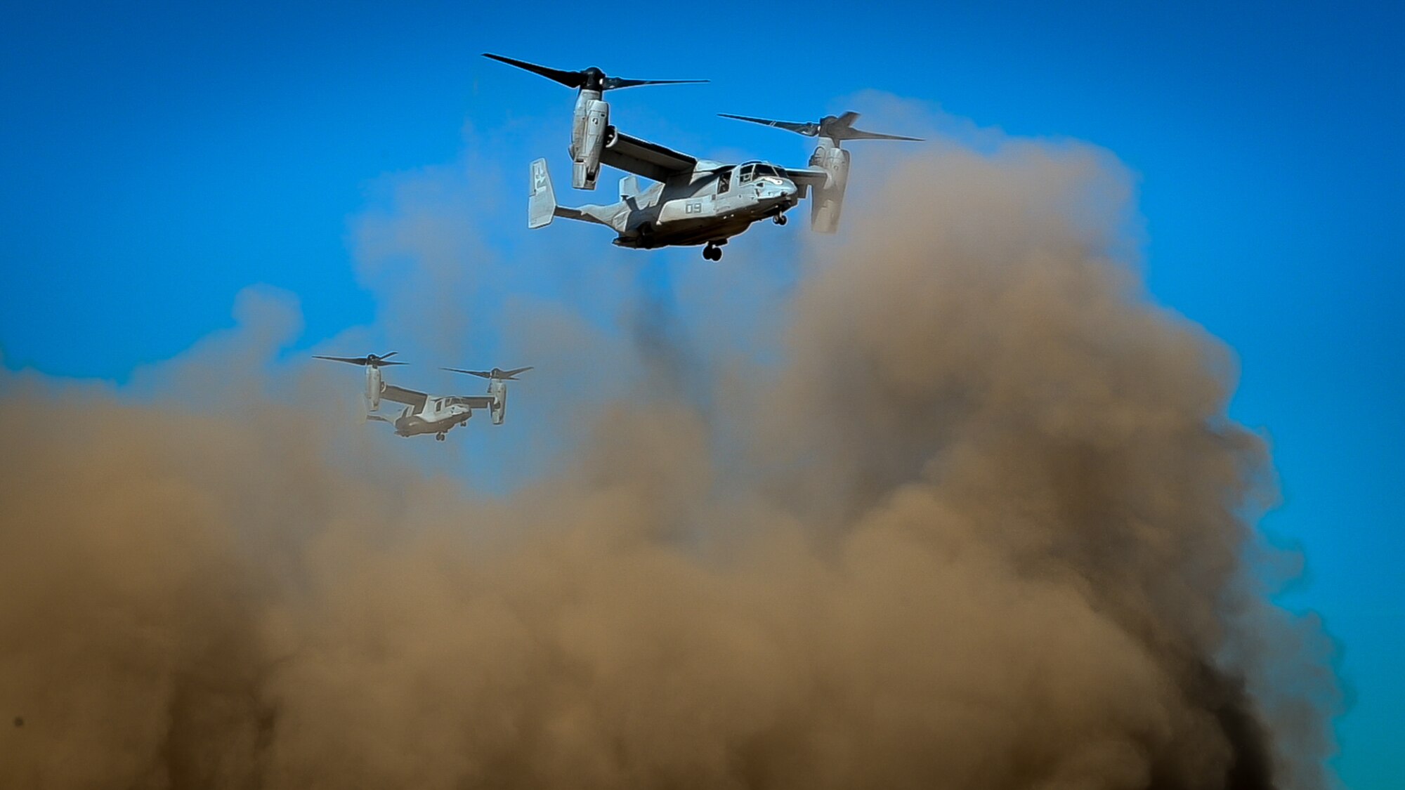 Marine Corps MV-22 Ospreys depart the flightline in a cloud of dust during Exercise Desert Hammer 25-1 at Luke Air Force Base, Ariz., Nov. 13, 2024. Set against the unmatched backdrop of the Barry M. Goldwater Range, Desert Hammer leverages Arizona’s strategic geography to provide realistic combat training for U.S. and allied forces. (U.S. Air Force photo by Senior Airman Alexis Orozco)