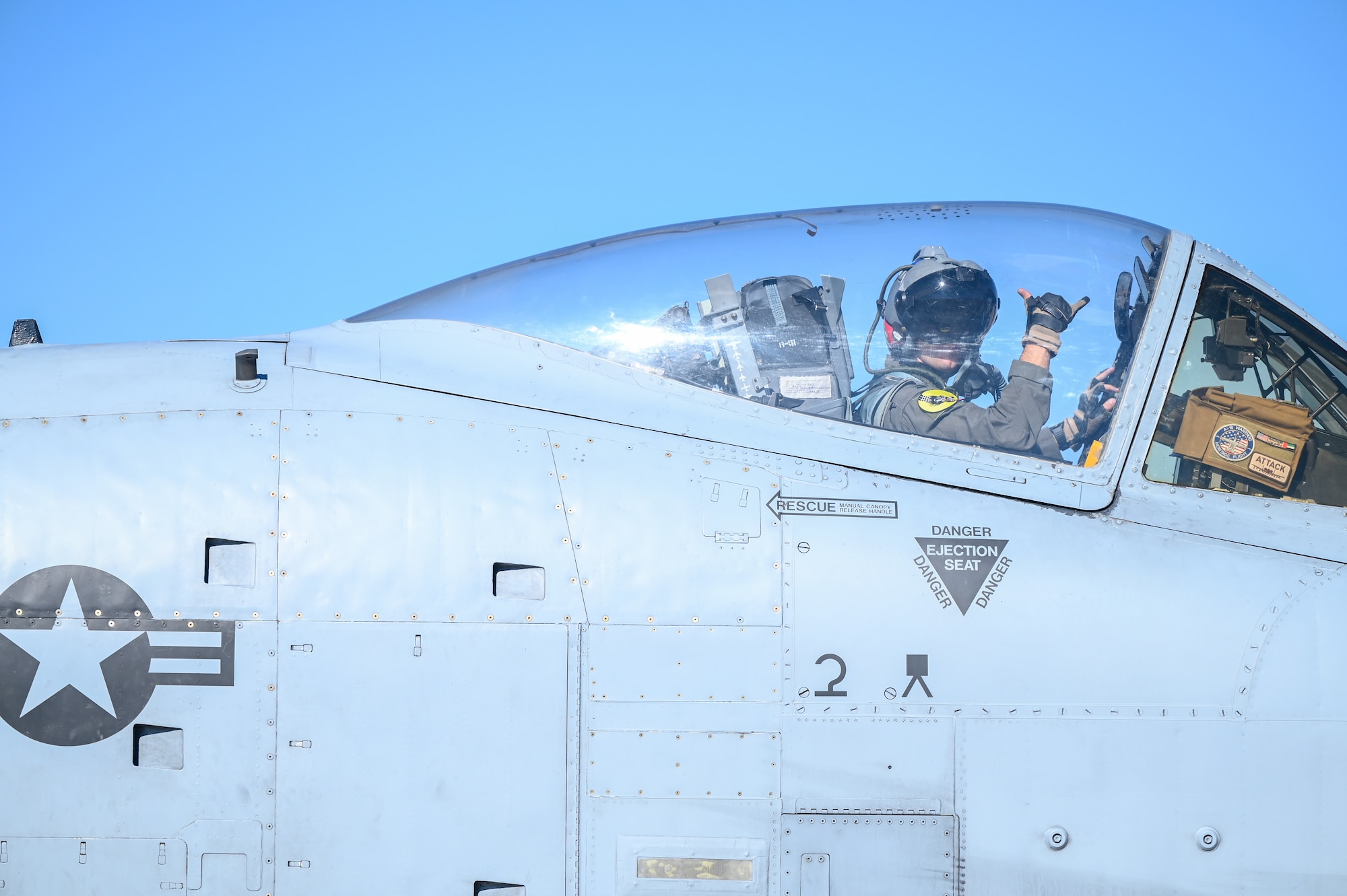 A pilot of an A-10 Thunderbolt II from the 924th Fighter Group signals to a crewmember on the ground during taxi operations at Davis-Monthan Air Force Base, Ariz., Nov. 14, 2024, as part of Exercise Desert Hammer 25-1 hosted by the 944th Fighter Wing. Exercise Desert Hammer 25-1 emphasizes the U.S. Air Force Reserve’s commitment to readiness by integrating Agile Combat Support and Large Force Exercise capabilities in a contested environment. (U.S. Air Force photo by Senior Airman Andrew Garavito)