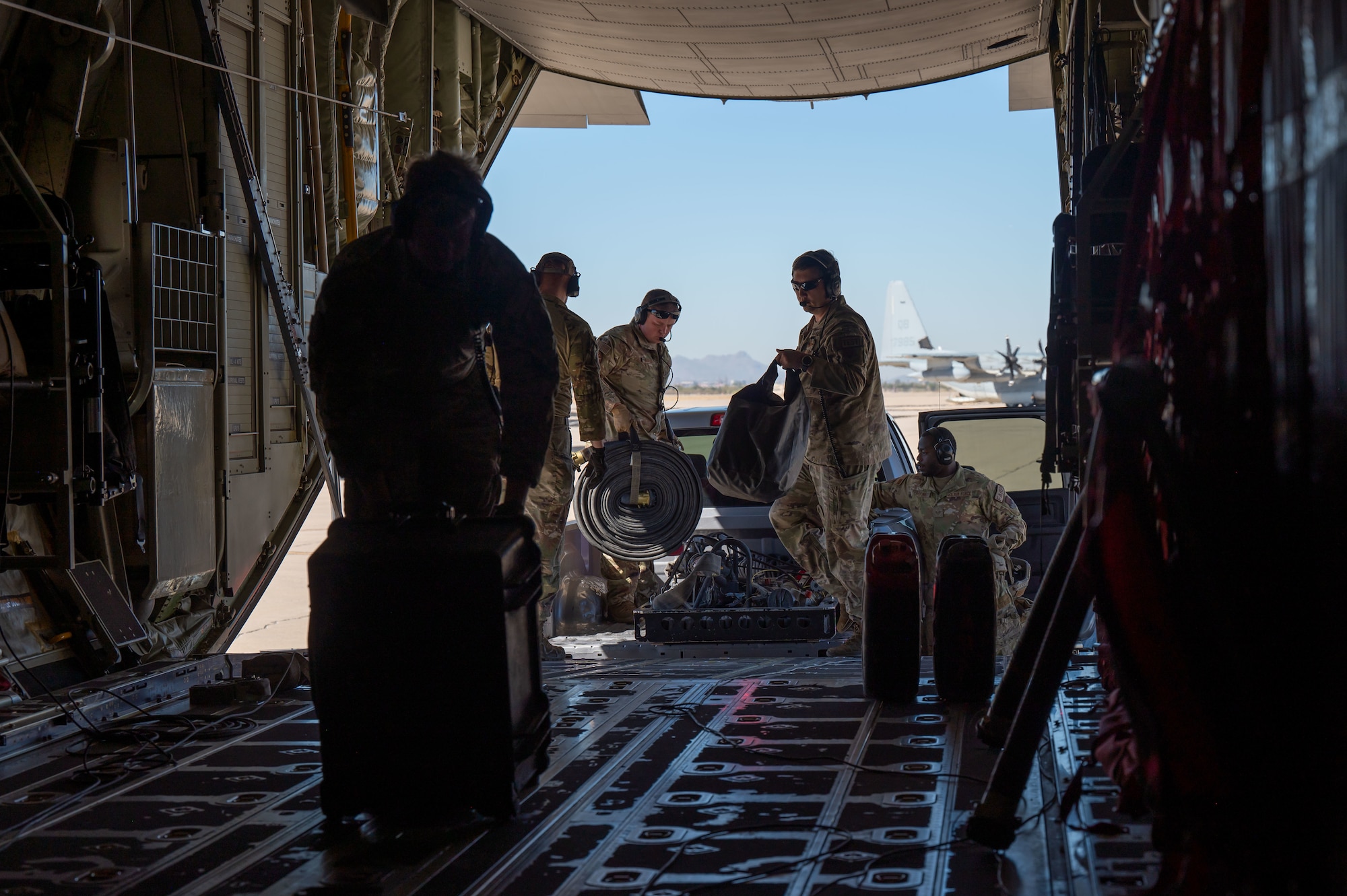 U.S. Air Force Airman from the 79th Rescue Squadron load and secure forward area refueling point equipment into a HC-130 Combat King II aircraft during the Desert Hammer 25-1 exercise at Davis-Monthan Air Force Base, Arizona, Nov. 14, 2024. Desert Hammer was a large-force joint exercise which included personnel from the U.S. Air Force, U.S. Marine Corps, and four allied nation’s militaries. (U.S. Air Force photo by Senior Airman Devlin Bishop)