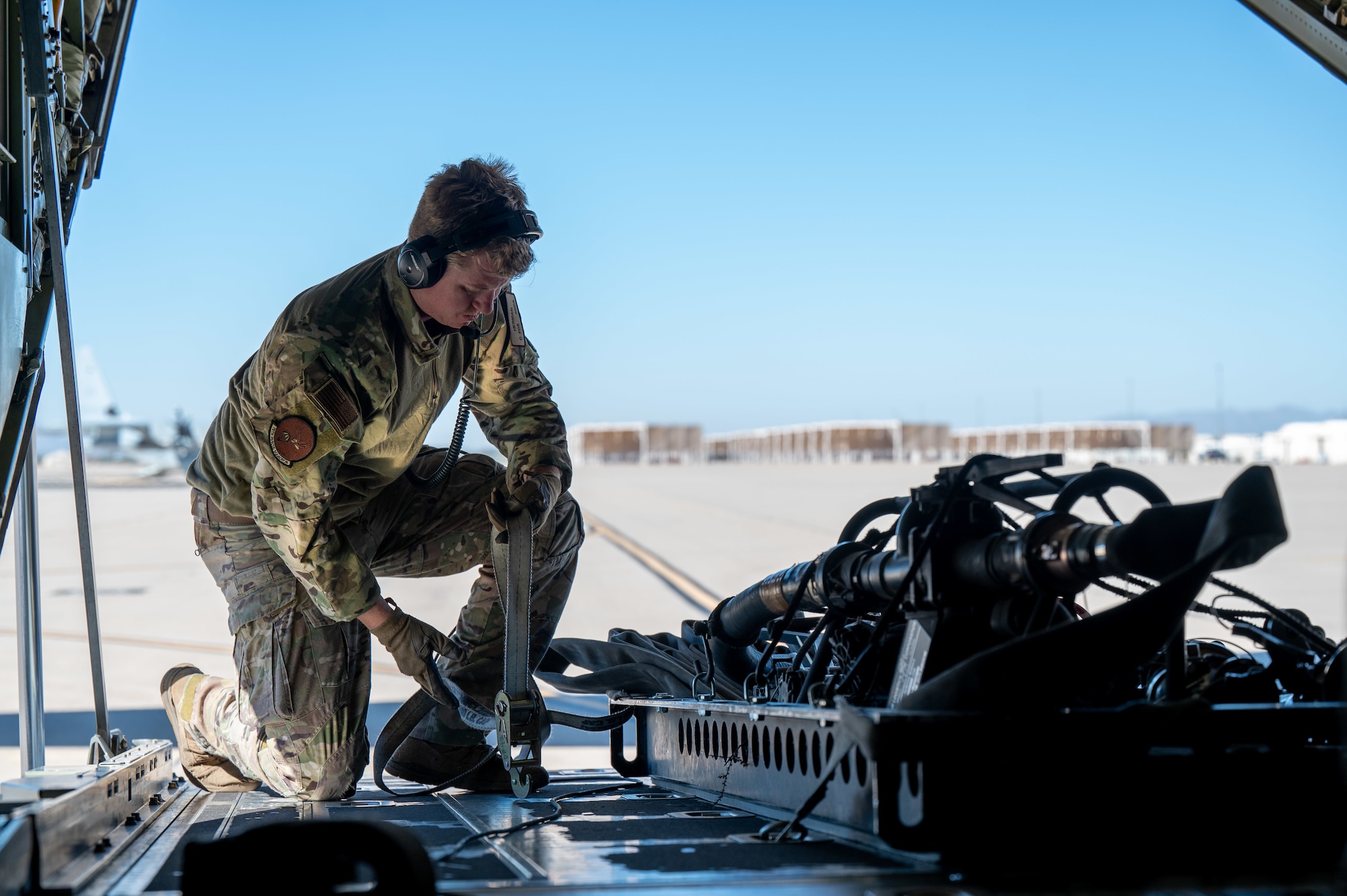 U.S. Air Force Staff Sgt. Brannon Herman, 79th Rescue Squadron tactics loadmaster, secures forward area refueling point equipment into a HC-130 Combat King II aircraft during the Desert Hammer 25-1 exercise at Davis-Monthan Air Force Base, Arizona, Nov. 14, 2024. Desert Hammer was a large-force joint exercise which included personnel from the U.S. Air Force, U.S. Marine Corps, and four allied nation’s militaries. (U.S. Air Force photo by Senior Airman Devlin Bishop)