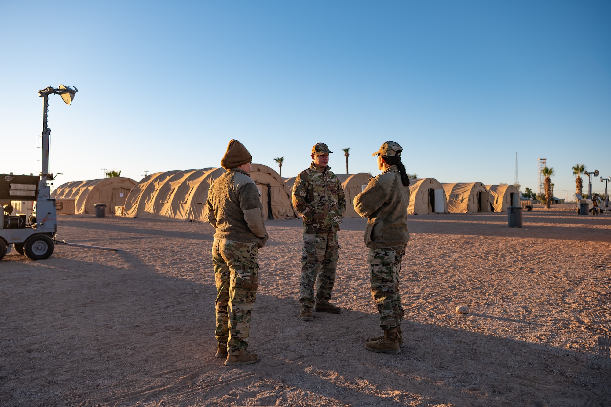 944th Fighter Wing Reserve Citizen Airmen discuss exercise logistics in the early morning during Exercise Desert Hammer 25-1 at Gila Bend Air Force Auxiliary Field, Ariz., Nov. 14, 2024. This large-scale exercise showcases the adaptability of Mission Ready Airmen, advancing the skills needed to thrive in the rapidly evolving challenges of global competition. (U.S. Air Force photo by Tech. Sgt. Tyler J. Bolken)