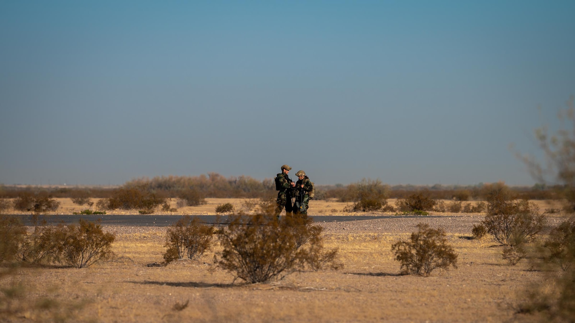 944th Fighter Wing U.S. Air Force Reserve Citizen Airmen dawn their Mission Oriented Protective Posture (MOPP) gear and conduct a simulated reconnaissance patrol at Auxiliary Field 6 near Gila Bend, Ariz., Nov. 15, 2024. Through joint and multinational collaboration, Desert Hammer tests the ability of over 700 participants and 131 aircraft to operate, defend, and sustain airbases under austere conditions. (U.S. Air Force photo by Senior Airman Jacob Dastas)