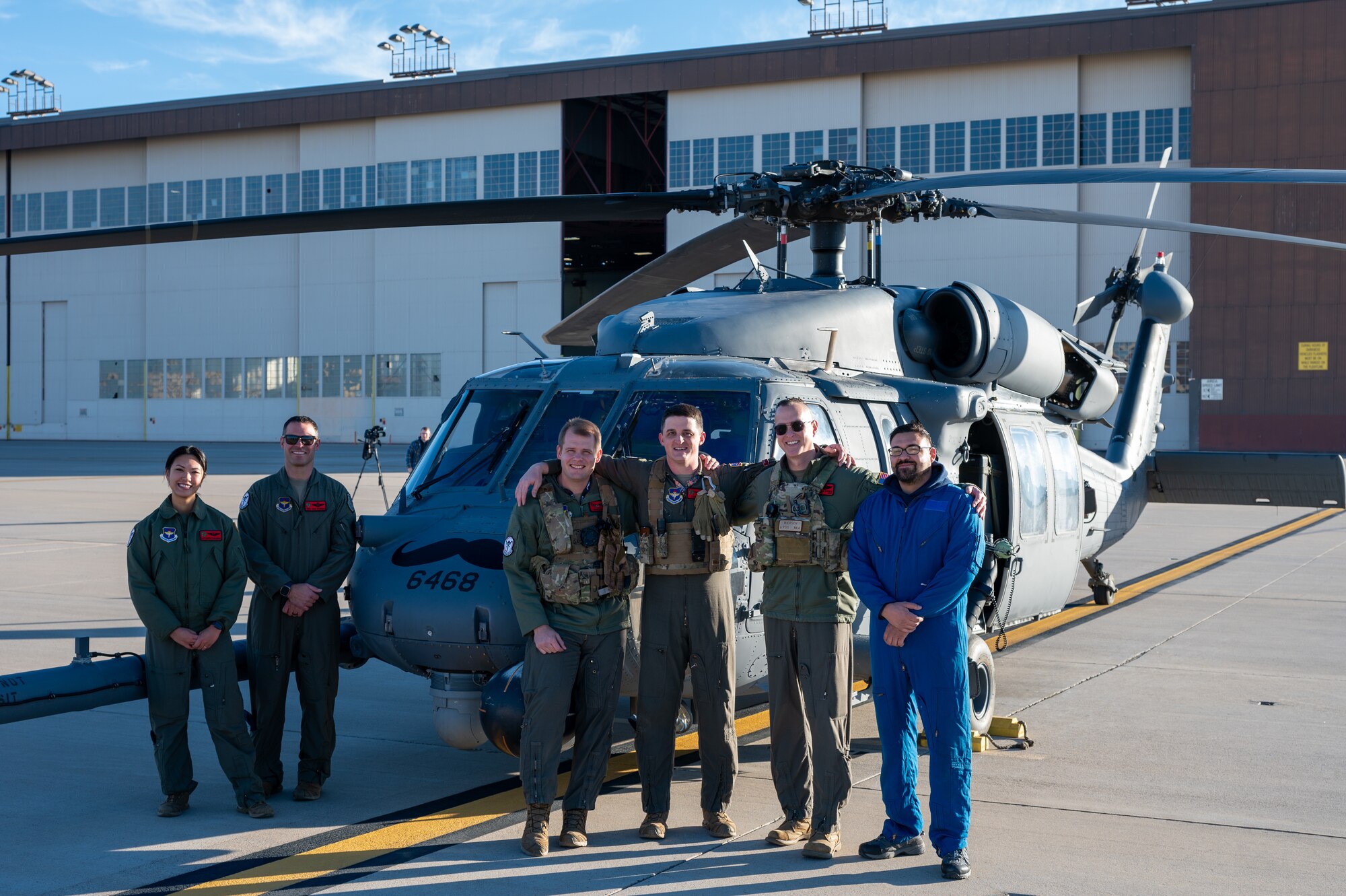 Members of the 58th Special Operations Wing pose in front of a HH-60G Pave Hawk helicopter at Kirtland Air Force Base, Albuquerque, N.M., Dec. 3. The Pave Hawk has been in service since the 1980s has been used in various combat and rescue operations since. (U.S. Air Force photo by Airman 1st Class Donnell Schroeter)