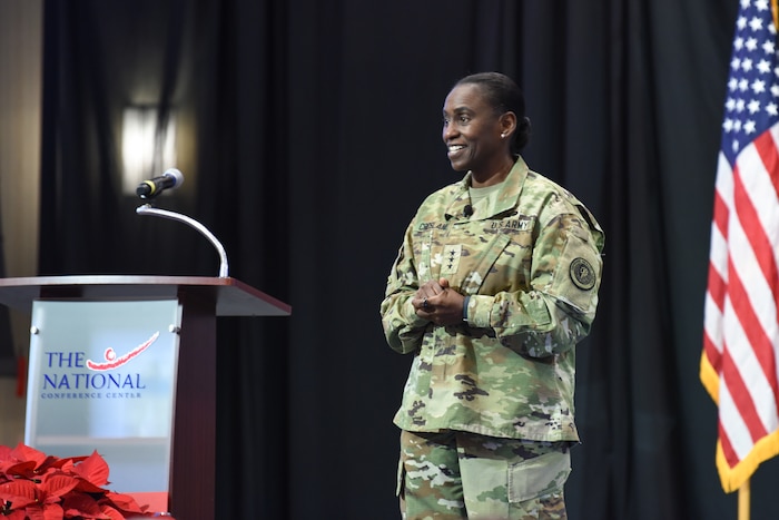 Image of a soldier talking to a group of people.