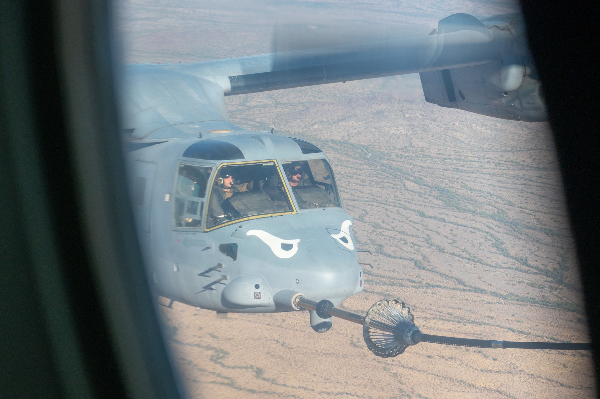 U.S. Marine Corps pilots refuel their MV-22 Osprey from an Air Force HC-130 Combat King II aircraft during the Desert Hammer 25-1 exercise over Barry M. Goldwater Range East in southern Arizona, Nov. 15, 2024. Desert Hammer was a large-force joint exercise which included a number of scenarios such as specialized refueling operations and casualty evacuation. (U.S. Air Force photo by Senior Airman Devlin Bishop)
