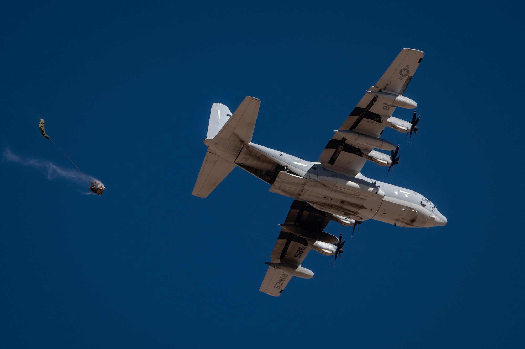 A KC-130J Hercules from the U.S. Marine Corps executes a low-level cargo drop flyover at Auxiliary Airfield 6 near Gila Bend, Ariz., Nov. 14, 2024. This exercise highlights the adaptability of Mission Ready Airmen and enhances their ability to sustain operations. (U.S. Air Force photo by Tech. Sgt. Tyler J. Bolken)