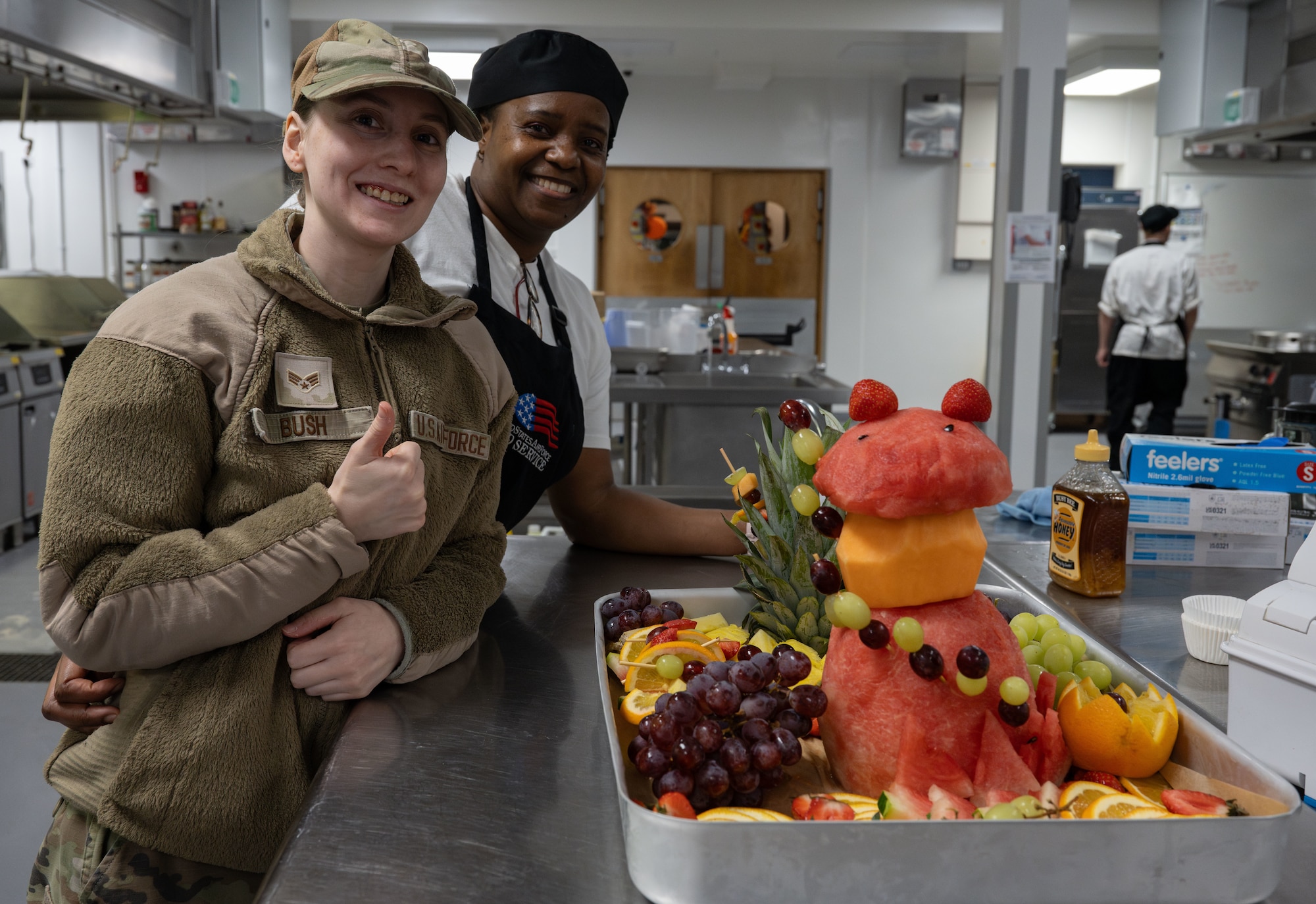 U.S. Air Force Senior Airman Tabatha Bush, left, 100th Force Support Squadron food service shift leader, and Stha Moya, 100th FSS first cook, pose for a photo at Royal Air Force Mildenhall, England, Nov. 27, 2024.