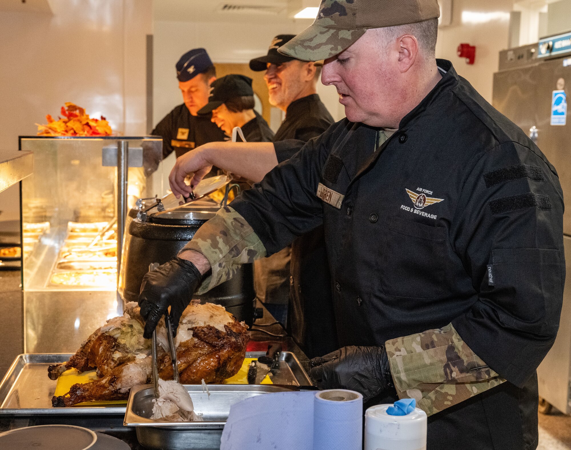 U.S. Air Force Chief Master Sgt. Jeffrey Lubben, 488th Intelligence Squadron senior enlisted leader, serves turkey at Royal Air Force Mildenhall, England, Nov. 27, 2024.