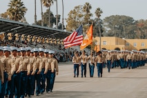 U.S. Marines with the regimental color guard lead Golf Company, 2nd Recruit Training Battalion, as they march across the parade deck during their graduation ceremony at Marine Corps Recruit Depot San Diego, California, Nov. 26, 2024. Graduation took place at the completion of the 13-week transformation, which included training for drill, marksmanship, basic combat skills, and Marine Corps customs and traditions. (U.S. Marine Corps photo by Cpl. Alexander O. Devereux)