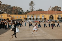 Families and guests of Golf Company, 2nd Recruit Training Battalion, run to greet their new Marines at the conclusion of a graduation ceremony at Marine Corps Recruit Depot San Diego, California, Nov. 26, 2024. Graduation took place at the completion of the 13-week transformation, which included training for drill, marksmanship, basic combat skills, and Marine Corps customs and traditions. (U.S. Marine Corps photo by Cpl. Alexander O. Devereux)