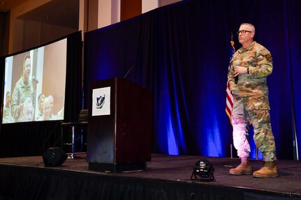 CMSgt Sundin stands on stage to give remarks at the State Partnership Program Conference in Las Vegas.