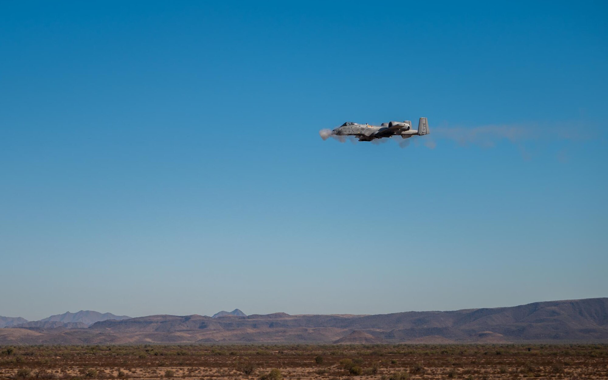 An A-10 Thunderbolt II from the 924th Fighter Group of the 944th Fighter Wing fires its 30mm GAU-8/A Avenger Gatling gun during Exercise Desert Hammer 25-1 at Barry M. Goldwater Range East near Gila Bend, Ariz., Nov. 14, 2024. Through joint and multinational collaboration, Desert Hammer tests the ability of over 700 participants and 131 aircraft to operate, defend, and sustain airbases under austere conditions. (U.S. Air Force photo by Senior Airman Jacob Dastas)