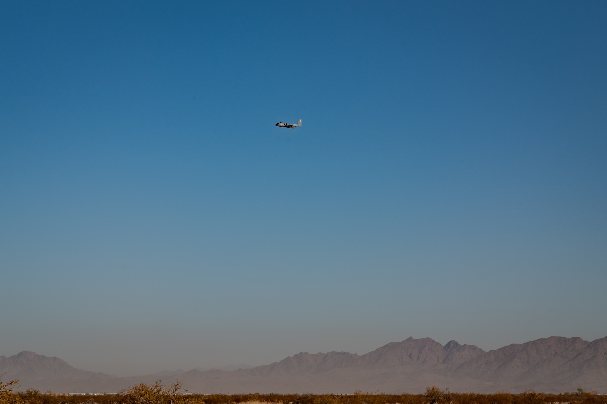 A U.S. Marine Corps KC-130J Hercules maneuvers during a cargo drop training operation as part of Exercise Desert Hammer 25-1 at Auxiliary Airfield 6 near Gila Bend, Ariz., Nov. 14, 2024, following a precision air drop. This large-scale exercise showcases the adaptability of Mission Ready Airmen, advancing the skills needed to thrive in the rapidly evolving challenges of global competition. (U.S. Air Force photo by Tech. Sgt. Tyler J. Bolken)