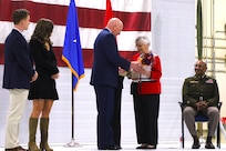 Brig. Gen. Daniel R. McDonough, Assistant Adjutant General - Air, Illinois National Guard, presents a bouquet of flowers to his mother during his promotion ceremony at the Peoria Air National Guard Base, Peoria, Illinois Nov. 27.
