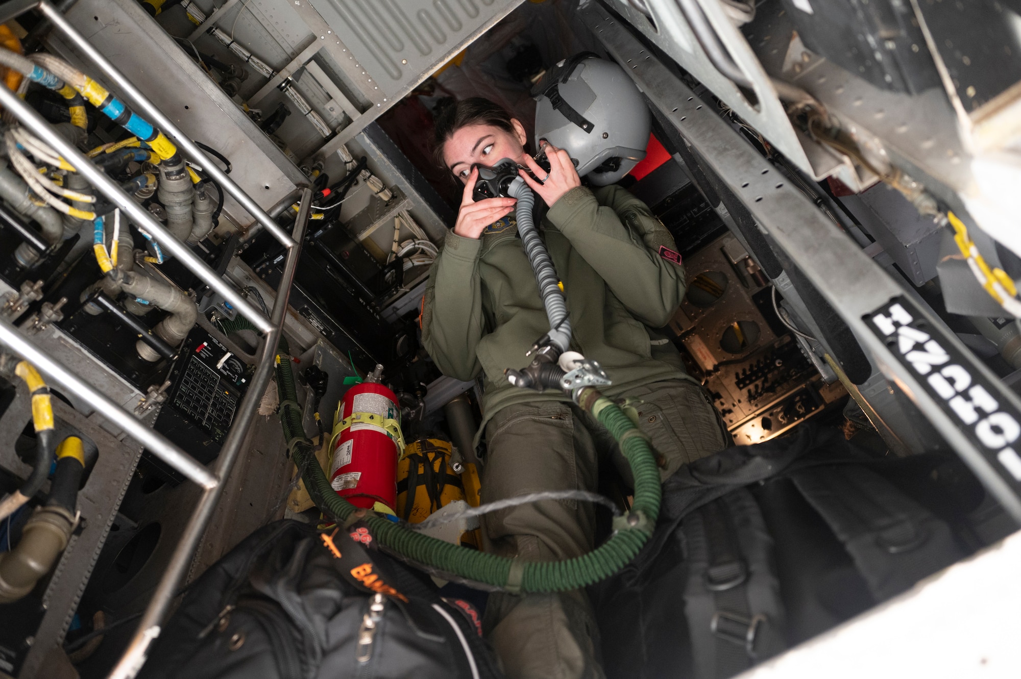 An Airman stands in a B-52 and listens to instructions before taking off.