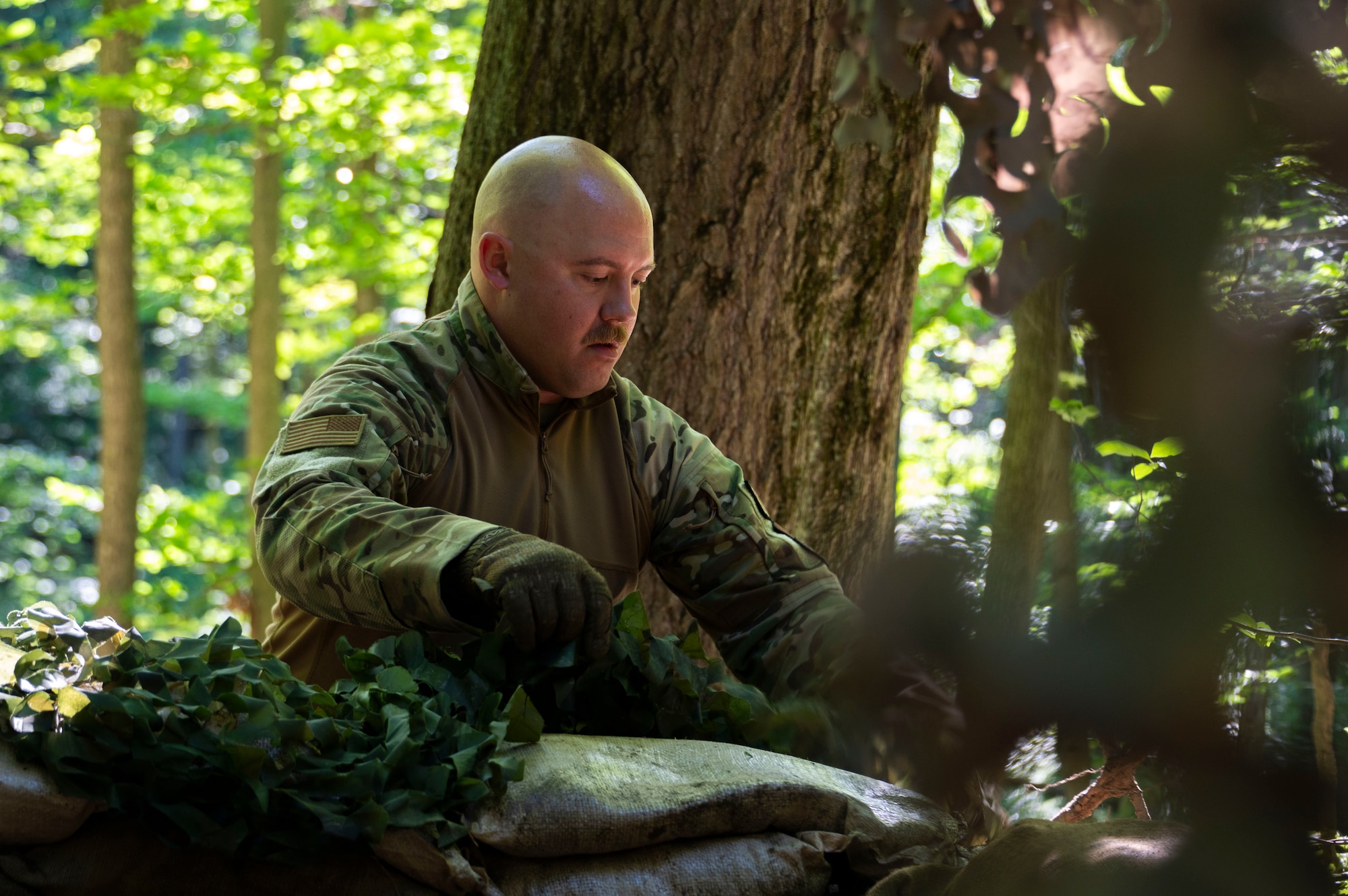 An Airman assigned to the 307th Security Forces Squadron sits to inspect his gear during a security exercise.