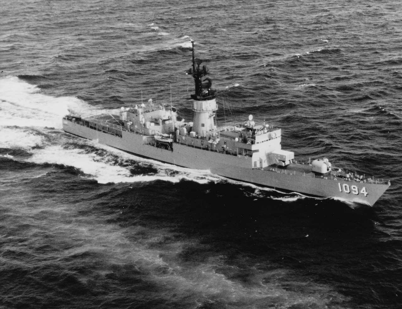 A ship glides through ocean water.