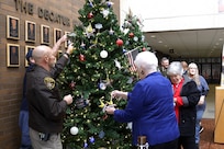 Gold Star Families place ornaments onto a tree in remembrance of the fallen Nov. 29 at the Decatur Civic Center in Decatur, Illinois.