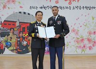 Staff Sgt. Shawn Kras, right, Eighth Army 35th Air Defense Artillery Brigade, was recognized for his heroic actions near Pyeongtaek.