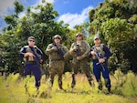 The U.S. Coast Guard team, comprised of members from the Forces Micronesia Sector Guam Sector Boarding Team and Port Security Unit 311, stands for a photo prior to the Battle of the Branches joint competitive marksmanship challenge at Andersen Air Force Base on Nov. 22, 2024. The inaugural event saw seven teams from multiple branches and the Guam Police Department shoot at nine stations testing their skills, building relationships, and sharpening collective readiness. (U.S. Coast Guard photo by Chief Warrant Officer Sara Muir)