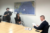 NCIS Special Agent James Curry speaks to a Honolulu-based investigative reporter Aug. 28, 2024, to discuss the cold case investigation into the 1980 murders of Marine Corps Lance Cpl. Lawrence Martens and Lance Cpl. Rodney Padilla.