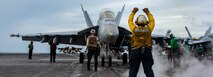 Aviation Boatswain’s Mate (Handling) 3rd class Daisy Rodrigues, from Los Angeles, directs an F/A-18F Super Hornet, attached to Strike Fighter Squadron (VFA) 41, on the flight deck of the Nimitz-class aircraft carrier USS Abraham Lincoln (CVN 72).