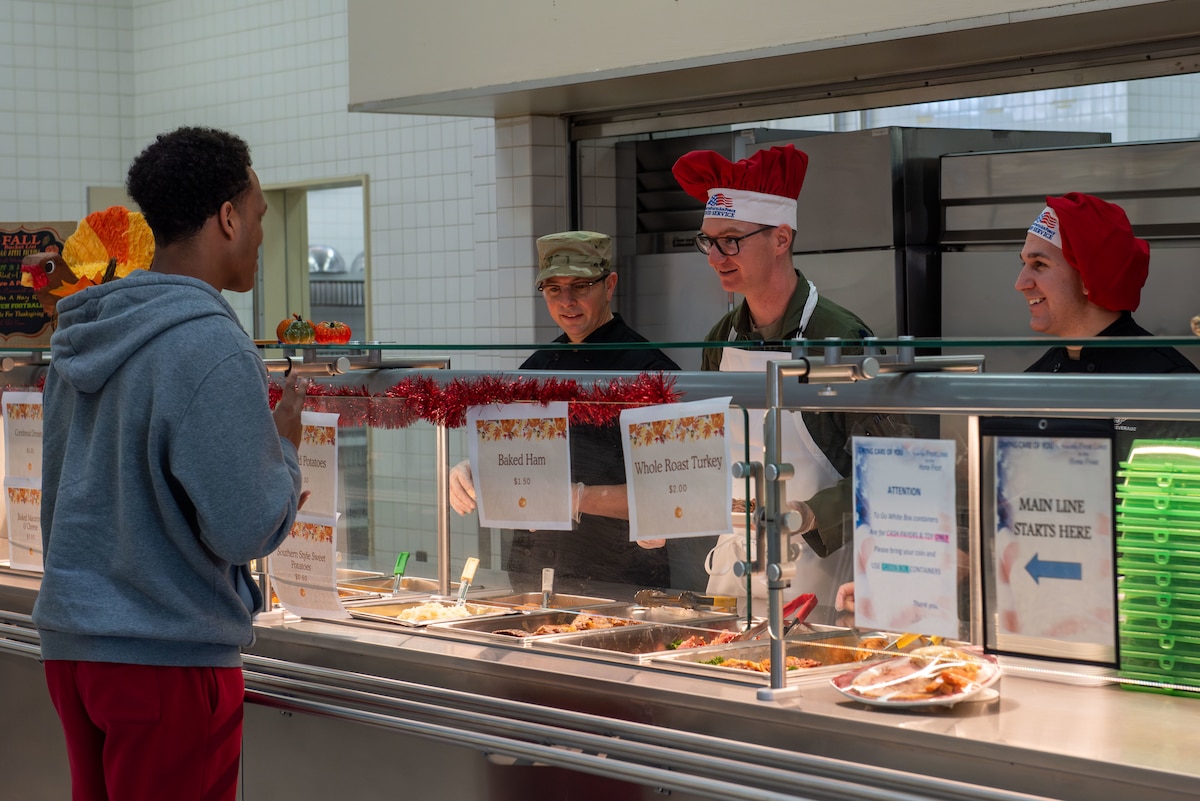 Chefs asking a customer for their meal order