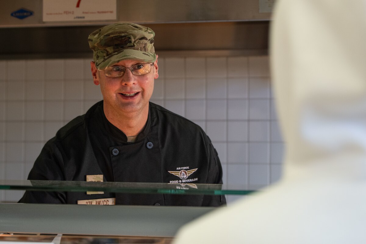 A person talking to another over a counter