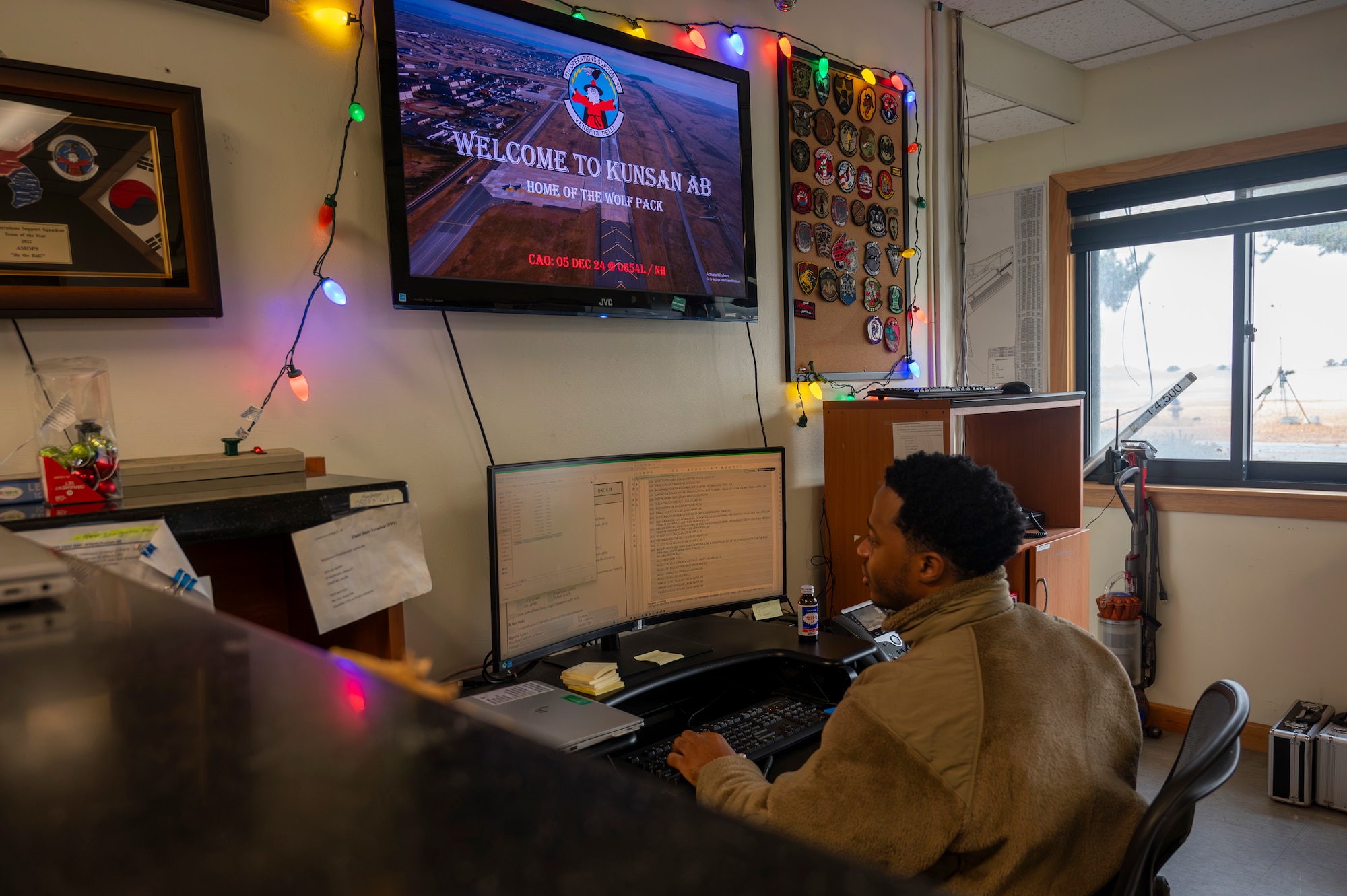 Senior Airman Nigel Harris, 8th Operational Support Squadron airfield management specialist, inputs data on a computer