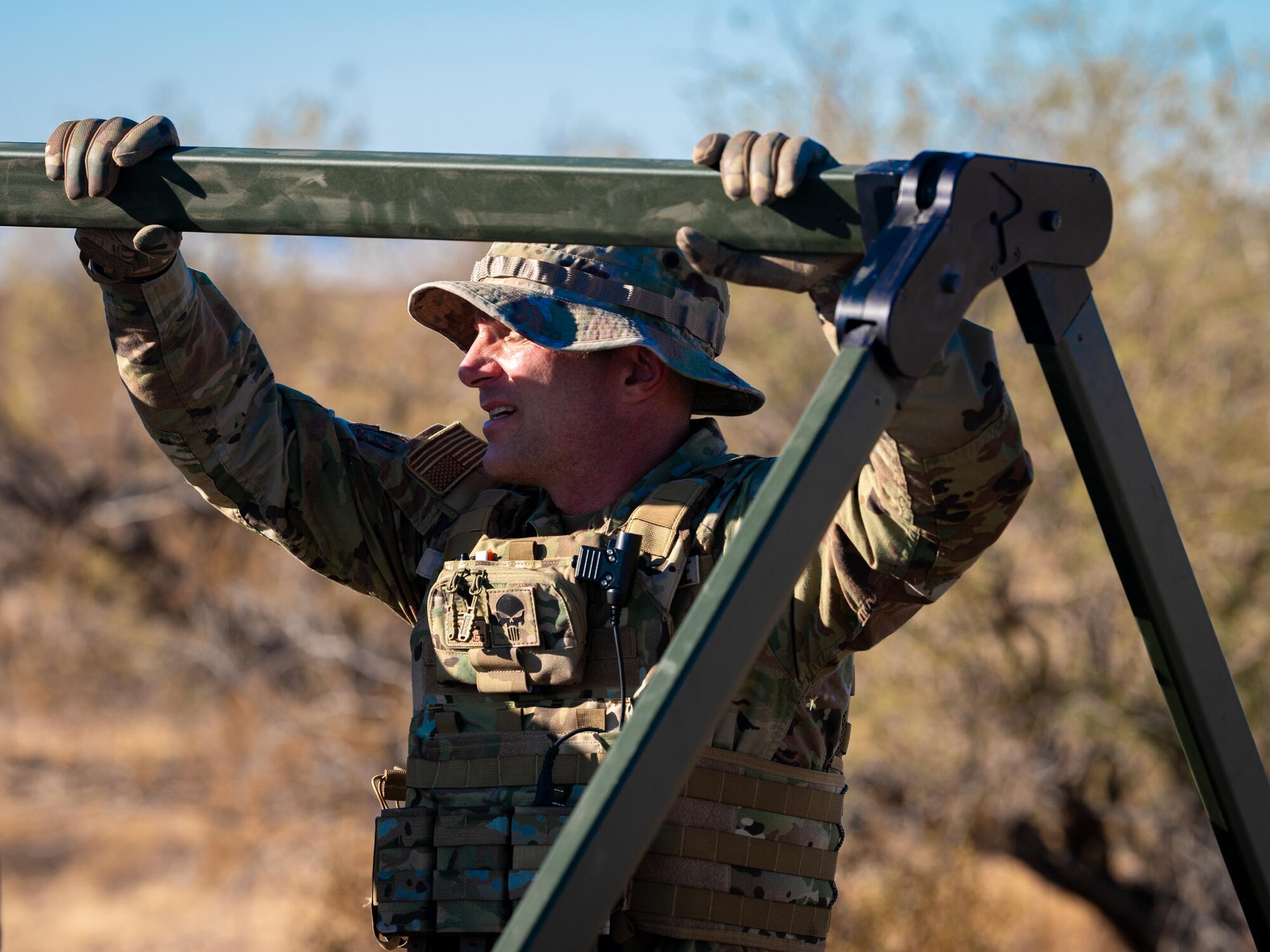 A 944th Fighter Wing Reserve Citizen Airman demonstrates tactical field exercises during Exercise Desert Hammer 25-1 at Auxiliary Airfield 6 near Gila Bend, Ariz., Nov. 14, 2024. This large-scale exercise showcases the adaptability of Mission Ready Airmen, advancing the skills needed to thrive in the rapidly evolving challenges of global competition. (U.S. Air Force photo by Senior Airman Jacob Dastas)