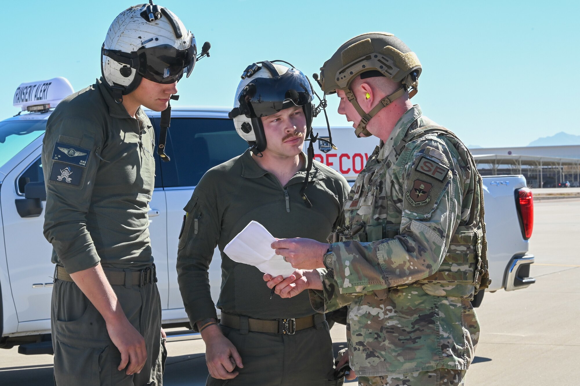 944th Fighter Wing Reserve Citizen Airmen and Marines review mission plans near a Marine Corps MV-22 Osprey during Exercise Desert Hammer 25-1 at Luke Air Force Base, Ariz., Nov. 13, 2024. This large-scale exercise showcases the adaptability of Mission Ready Airmen, advancing the skills needed to thrive in the rapidly evolving challenges of global competition. (U.S. Air Force photo by Senior Airman Alexis Orozco)
