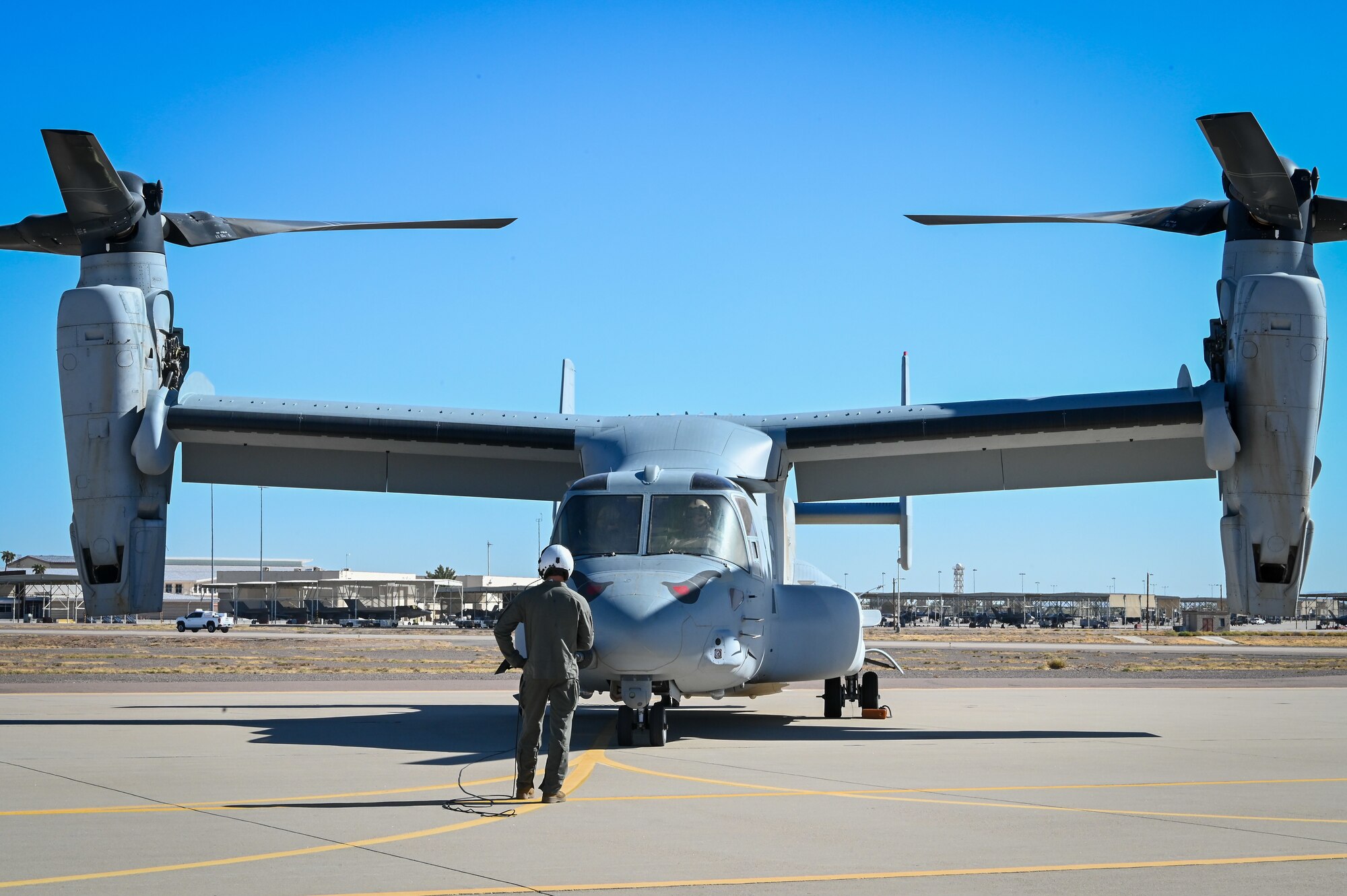 A Marine conducts a preflight check on an MV-22 Osprey during Exercise Desert Hammer 25-1 at Luke Air Force Base, Ariz., Nov. 13, 2024. Exercise Desert Hammer 25-1 emphasizes the U.S. Air Force Reserve’s commitment to readiness by integrating Agile Combat Support and Large Force Exercise capabilities in a contested environment. (U.S. Air Force photo by Senior Airman Alexis Orozco)