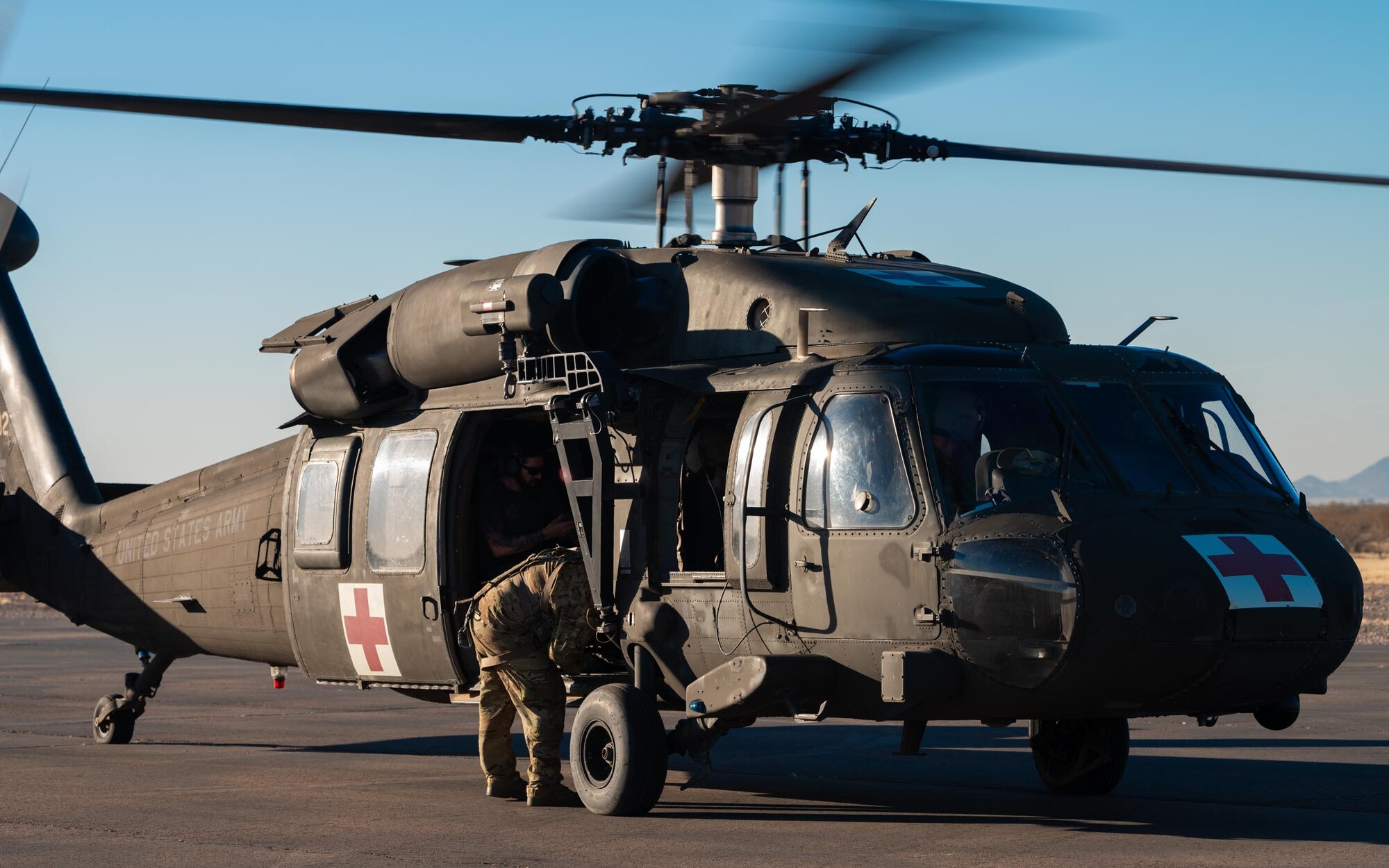 An Arizona Army National Guard UH-60 Black Hawk prepares for medical evacuation operations at Auxiliary Airfield 6 near Gila Bend, Ariz., Nov. 14, 2024. Through joint and multinational collaboration, Desert Hammer tests the ability of over 700 participants and 131 aircraft to operate, defend, and sustain airbases under austere conditions. (U.S. Air Force photo by Senior Airman Jacob Dastas)