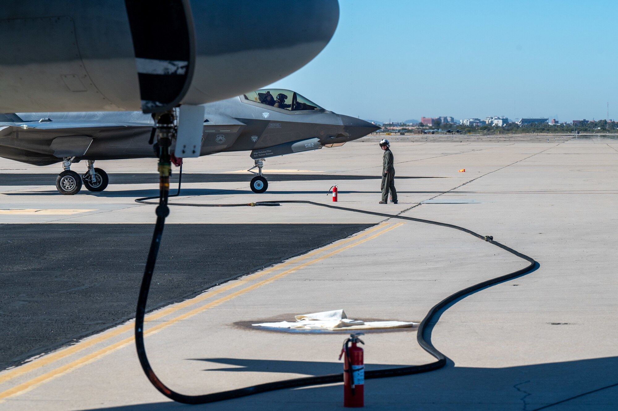 U.S. Marines refuel an F-35 Lightning II aircraft, assigned to the 56th Fighter Wing’s 62nd Fighter Squadron, on the flightline at Davis-Monthan Air Force Base, Ariz., Nov. 14, 2024. The Marines and F-35s participated in Exercise Desert Hammer 25-1, to include a forward area refueling point training. (U.S. Air Force photo by Senior Airman Devlin Bishop)