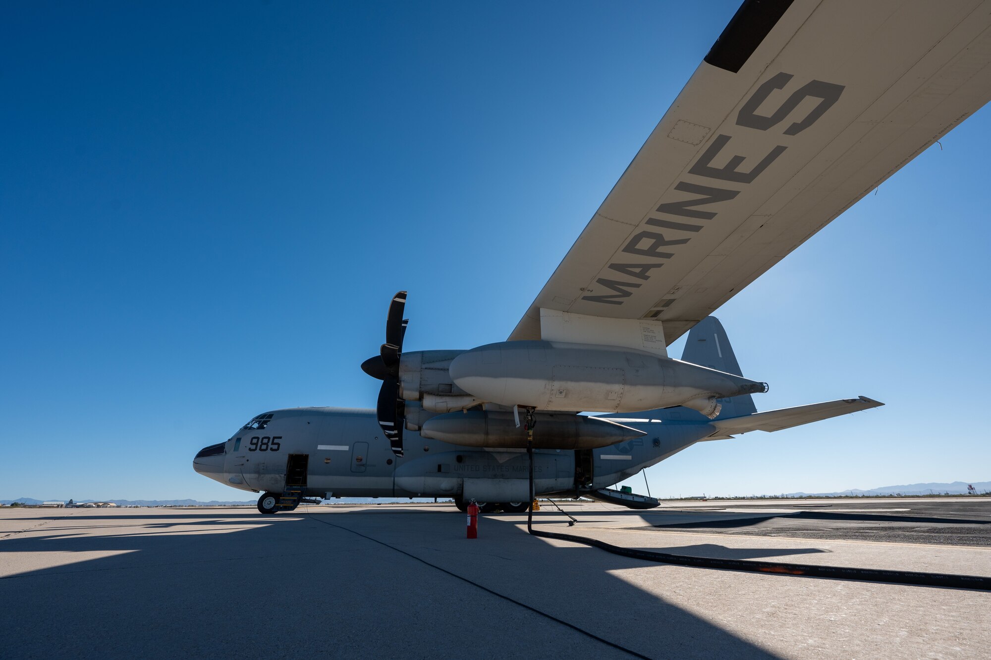 A U.S. Marine Corps KC-130J Hercules stages on the flightline at Davis-Monthan Air Force Base, Ariz., Nov. 14, 2024, awaiting cargo to be loaded for cargo drops as part of Exercise Desert Hammer 25-1. Through joint and multinational collaboration, Desert Hammer tests the ability of over 700 participants and 131 aircraft to operate, defend, and sustain airbases under austere conditions. (U.S. Air Force photo by Senior Airman Devlin Bishop)