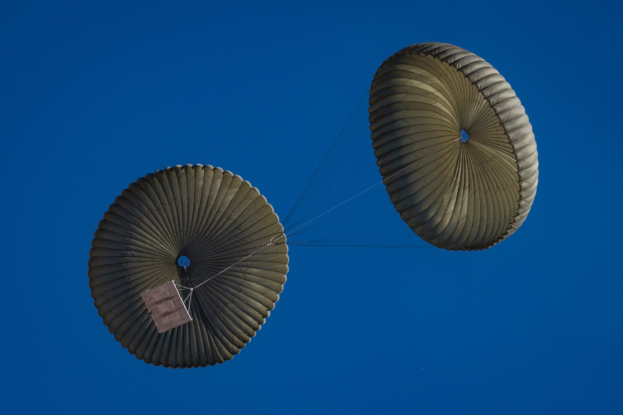 A large cargo bundle safely descends after being dropped from a U.S. Marine Corps KC-130J Hercules during an Exercise Desert Hammer 25-1 training mission at Auxiliary Airfield 6 near Gila Bend, Ariz., Nov. 14, 2024. Exercise Desert Hammer tests the operational readiness of over 700 participants across the Air Force Reserve, Air Force Active Duty, Arizona Army National Guard, and U.S. Marine Corps. (U.S. Air Force photo by Tech. Sgt. Tyler J. Bolken)