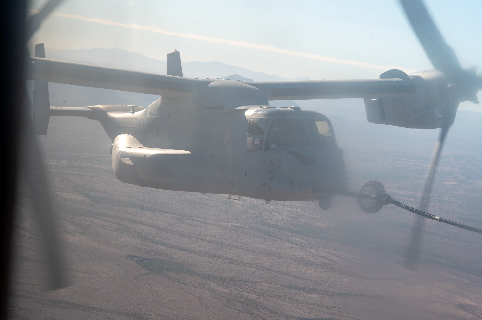U.S. Marine Corps pilots refuel their MV-22 Osprey from an Air Force HC-130 Combat King II aircraft during the Desert Hammer 25-1 exercise over Barry M. Goldwater Range East in southern Arizona, Nov. 15, 2024. Desert Hammer was a large-force joint exercise which included a number of scenarios such as specialized refueling operations and casualty evacuation. (U.S. Air Force photo by Senior Airman Devlin Bishop)