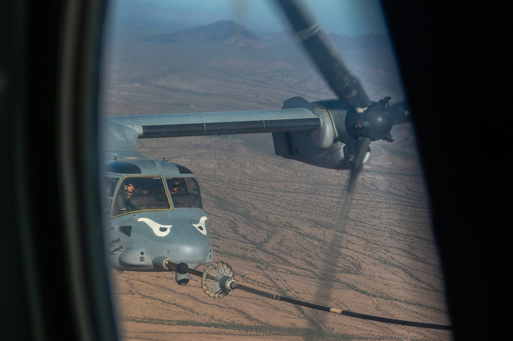 U.S. Marine Corps pilots refuel their MV-22 Osprey from an Air Force HC-130 Combat King II aircraft during the Desert Hammer 25-1 exercise over Barry M. Goldwater Range East in southern Arizona, Nov. 15, 2024. Desert Hammer was a large-force joint exercise which included a number of scenarios such as specialized refueling operations and casualty evacuation. (U.S. Air Force photo by Senior Airman Devlin Bishop)