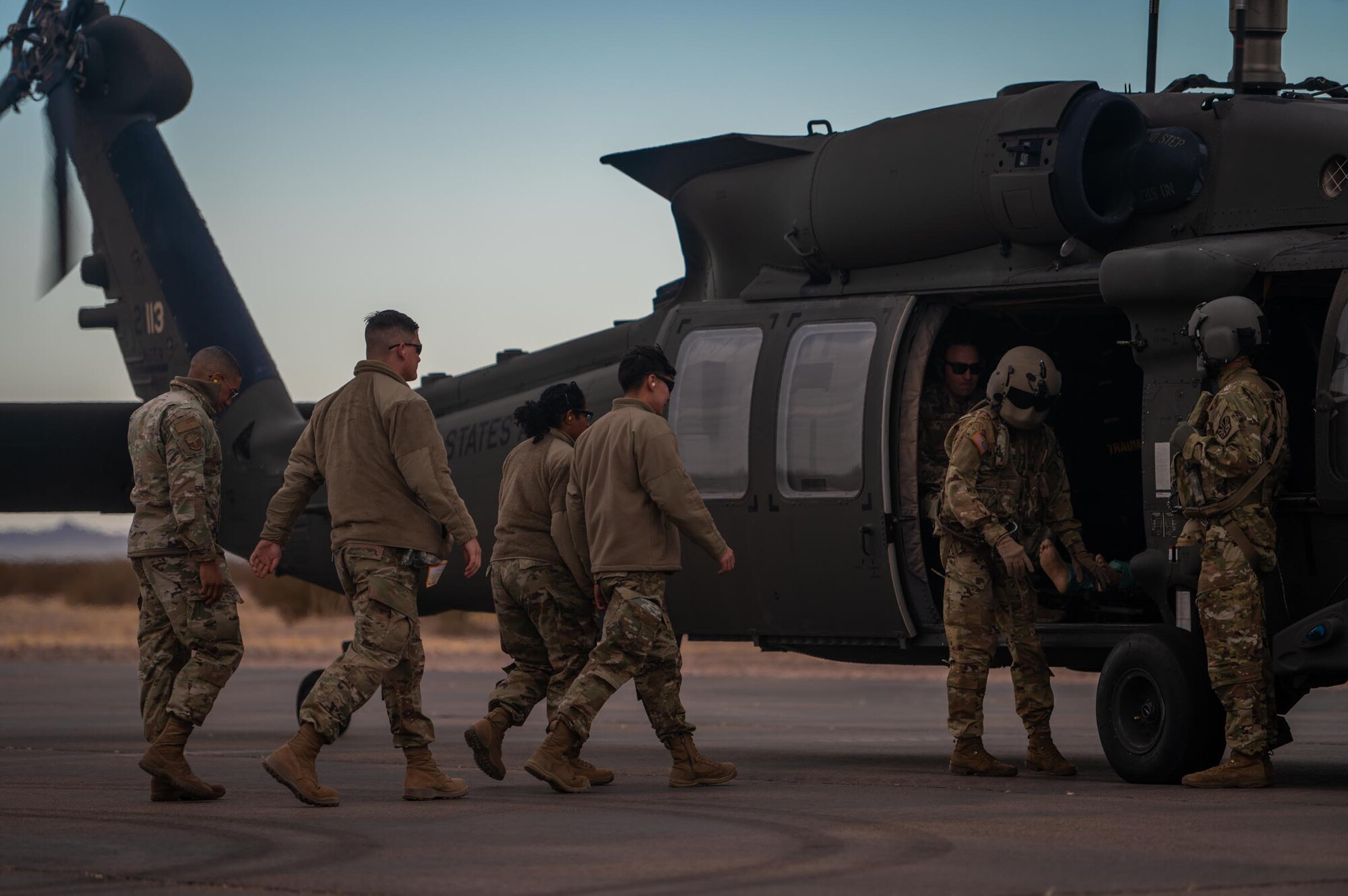 944th Fighter Wing U.S. Air Force Reserve Citizen Airmen and Arizona Army National Guard Soldiers work together to load simulated casualty aboard a AZ-ANG UH-60 Black Hawk Helicopter during Critical Care Air Transport Team (CCATT) training at Auxiliary Field 6 near Gila Bend, Ariz., Nov. 16, 2024. Through joint and multinational collaboration, Desert Hammer tests the ability of over 700 participants and 131 aircraft to operate, defend, and sustain airbases under austere conditions. (U.S. Air Force photo by Senior Airman Jacob Dastas)