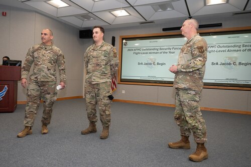 Senior leaders present an award to airman