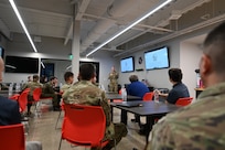Polish and U.S. Air Force Airman stand in a breakroom and talk.