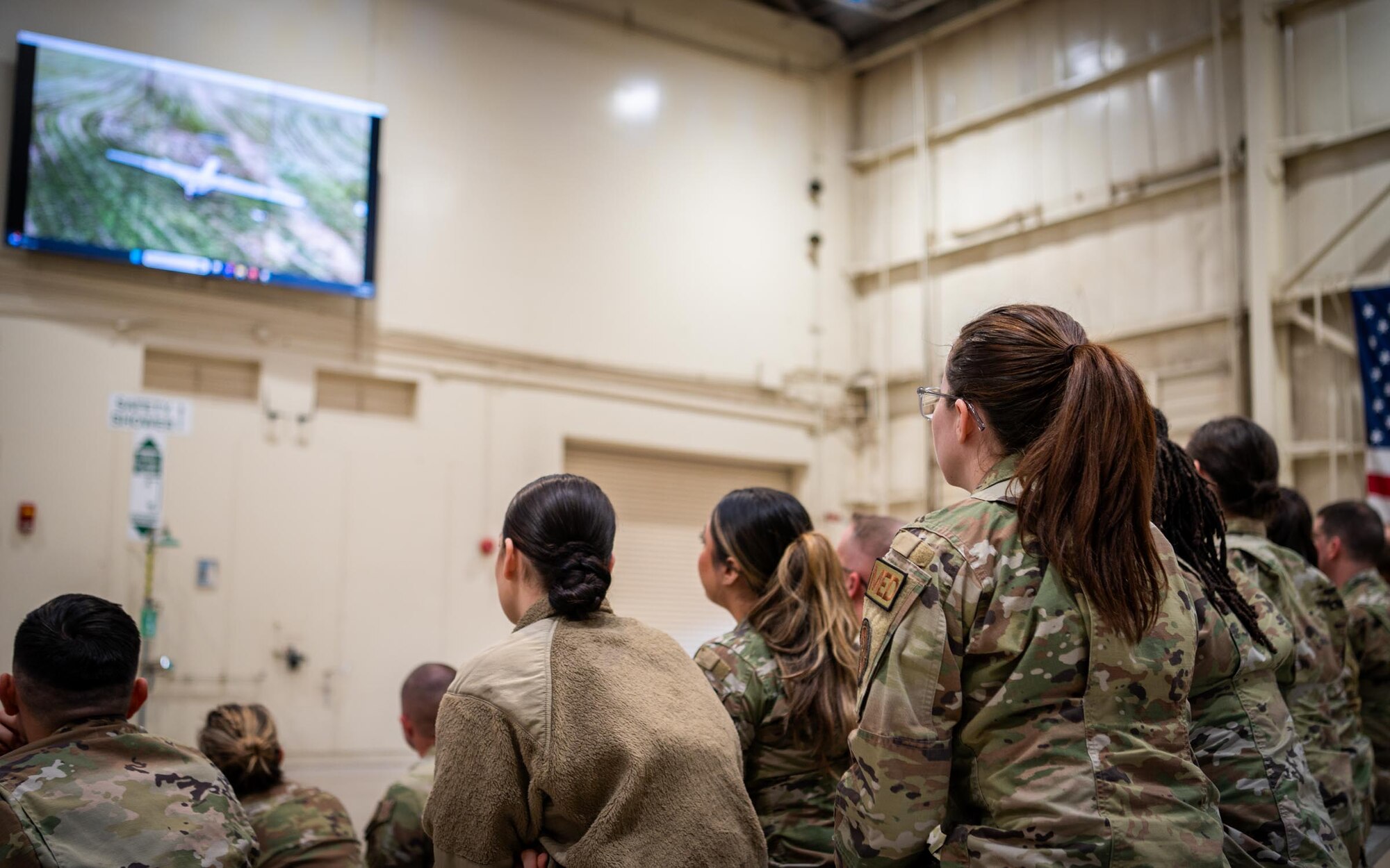 944th Fighter Wing Airmen Reserve Citizen review video footage during a Ready Start Brief as part of Exercise Desert Hammer 25-1 at Luke Air Force Base, Ariz., Nov. 13, 2024. Through joint and multinational collaboration, Desert Hammer tests the ability of over 700 participants and 131 aircraft to operate, defend, and sustain airbases under austere conditions. (U.S. Air Force photo by Senior Airman Jacob Dastas)