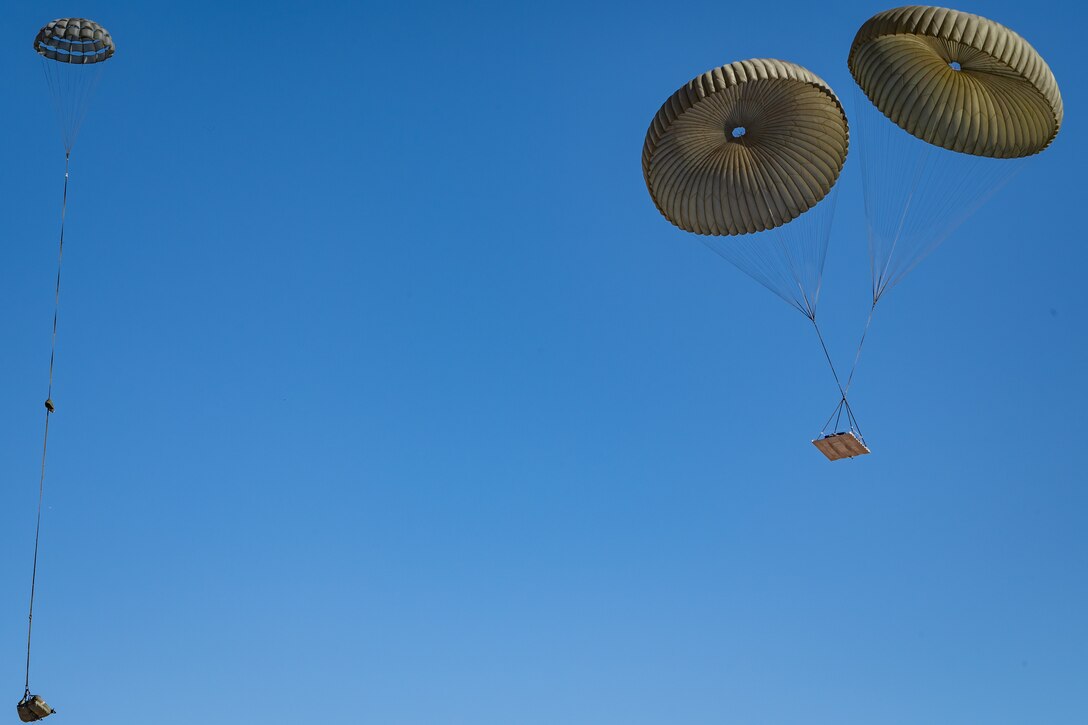 Large and small cargo bundles safely descend after being dropped from a U.S. Marine Corps KC-130J Hercules during an Exercise Desert Hammer 25-1 training mission at Auxiliary Airfield 6 near Gila Bend, Ariz., Nov. 14, 2024. Exercise Desert Hammer tests the operational readiness of over 700 participants across the Air Force Reserve, Air Force Active Duty, Arizona Army National Guard, and U.S. Marine Corps. (U.S. Air Force photo by Tech. Sgt. Tyler J. Bolken)