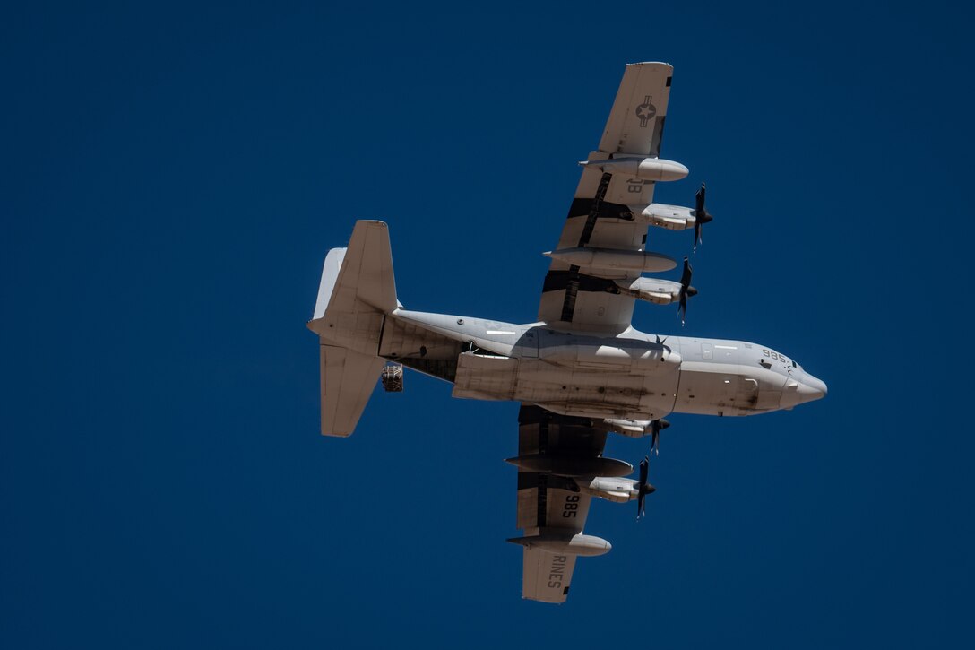 Cargo is released from a U.S. Marine Corps KC-130J Hercules during a training mission for Exercise Desert Hammer 25-1 at Auxiliary Airfield 6 near Gila Bend, Ariz., Nov. 14, 2024. This Large Force Exercise with joint counterparts underscores the U.S. Air Force Reserve’s commitment to readiness. (U.S. Air Force photo by Tech. Sgt. Tyler J. Bolken)