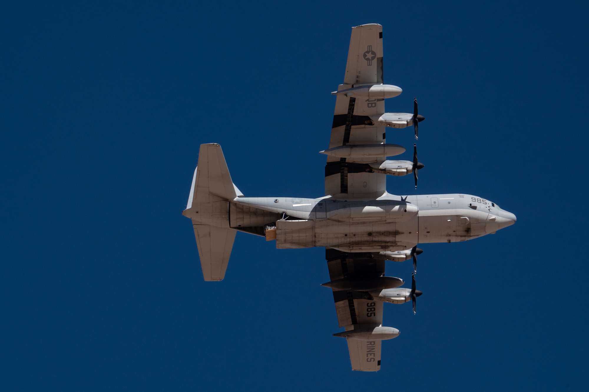 Cargo begins to descend out the back of a U.S. Marine Corps KC-130J Hercules during Exercise Desert Hammer 25-1 at Auxiliary Airfield 6 near Gila Bend, Ariz., Nov. 14, 2024. The exercise integrates Agile Combat Support and Large Force Exercise capabilities in a contested environment. (U.S. Air Force photo by Tech. Sgt. Tyler J. Bolken)