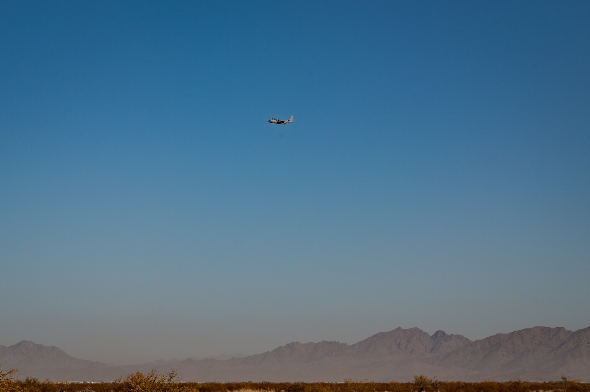 A U.S. Marine Corps KC-130J Hercules maneuvers during a cargo drop training operation as part of Exercise Desert Hammer 25-1 at Auxiliary Airfield 6 near Gila Bend, Ariz., Nov. 14, 2024, following a precision air drop. This large-scale exercise showcases the adaptability of Mission Ready Airmen, advancing the skills needed to thrive in the rapidly evolving challenges of global competition. (U.S. Air Force photo by Tech. Sgt. Tyler J. Bolken)